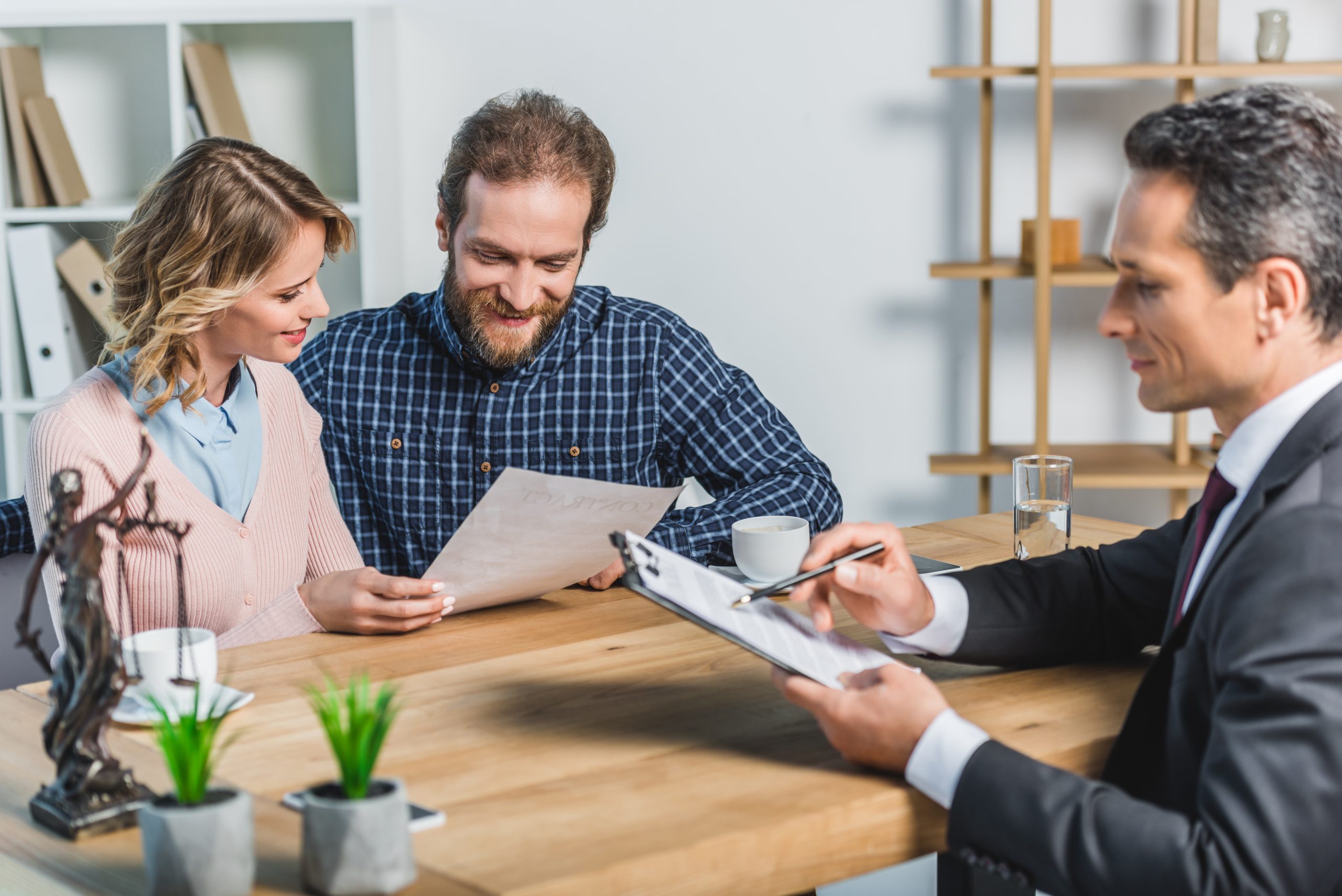 Smiling Couple Reading Contract - EDATA MEDIA ADVERTISING AND MARKETING GROUP